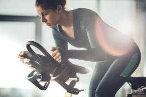 女人在固定自行车上降低运动时间