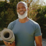 裁剪的肖像一个快乐的老人站在他的后花园瑜伽课前
